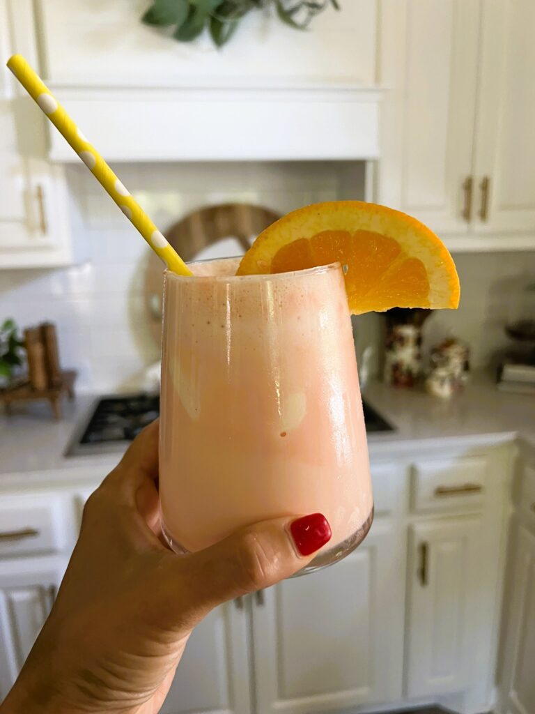 Aperol Float in a stemless glass garnished with an orange slice