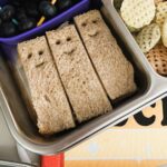 Smiley Face Sandwiches in a metal lunchbox