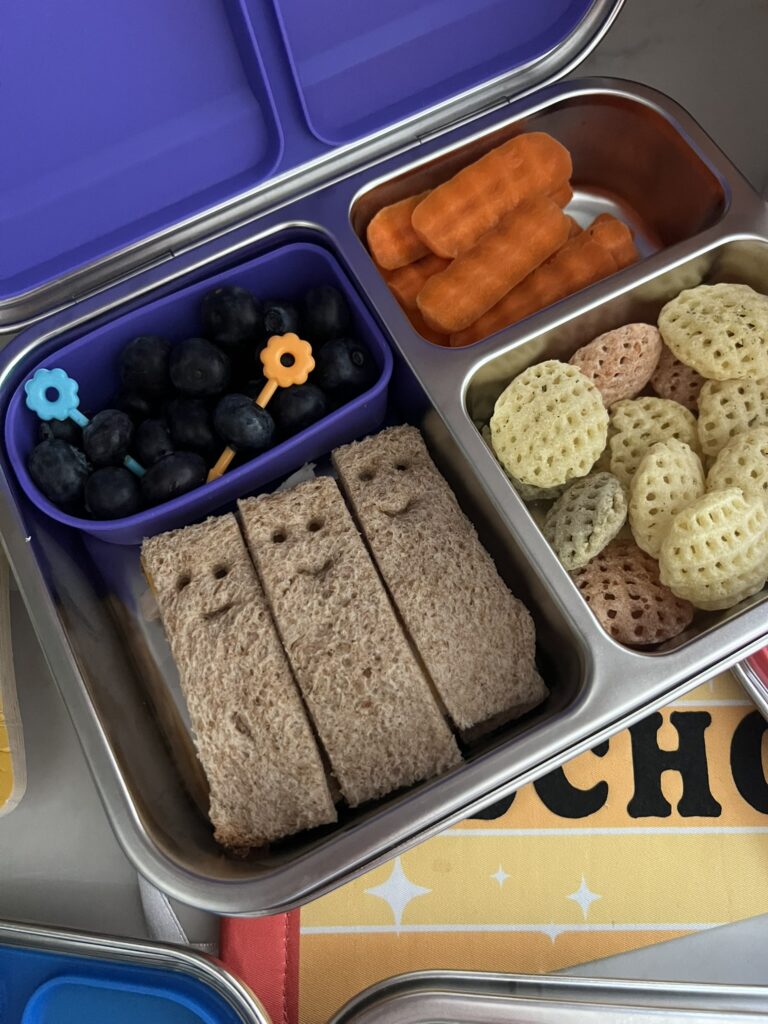 Smiley Face Sandwiches in a metal lunch tin