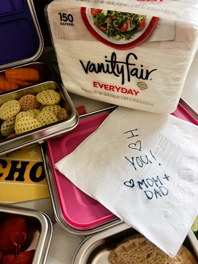 "I love you" written on a Vanity Fair napkin for a child's lunch