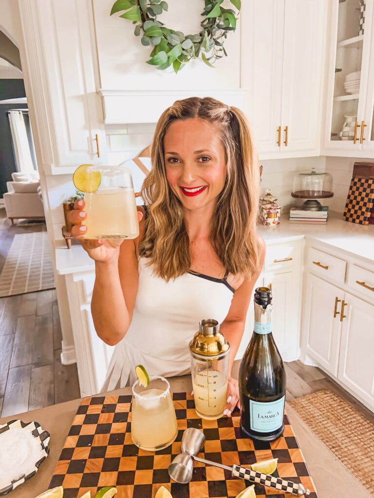 Leanna holding a glass of Prosecco Margaritas