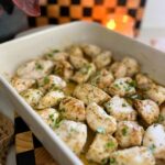 Chicken Bites sprinkled with seasoning in a white pan