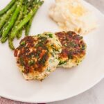 spinach and feta burger plated and served with potatoes and green beans