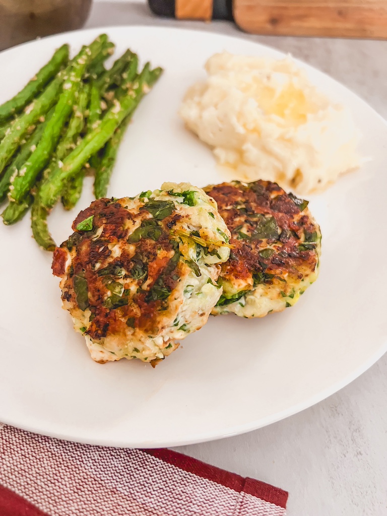 spinach and feta burger plated and served with potatoes and green beans