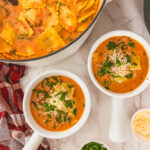 Creamy ravioli soup in a white bowl, an easy family friendly dinner recipe