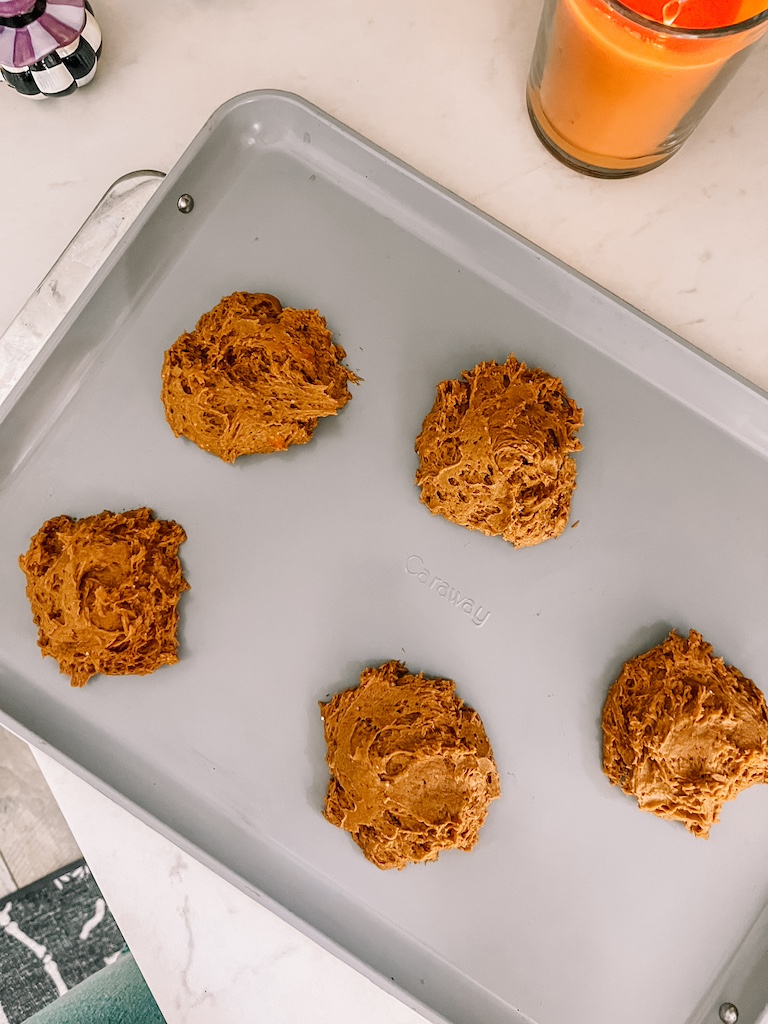 Unbaked pumpkin cookie dough mounds ready to go into the oven