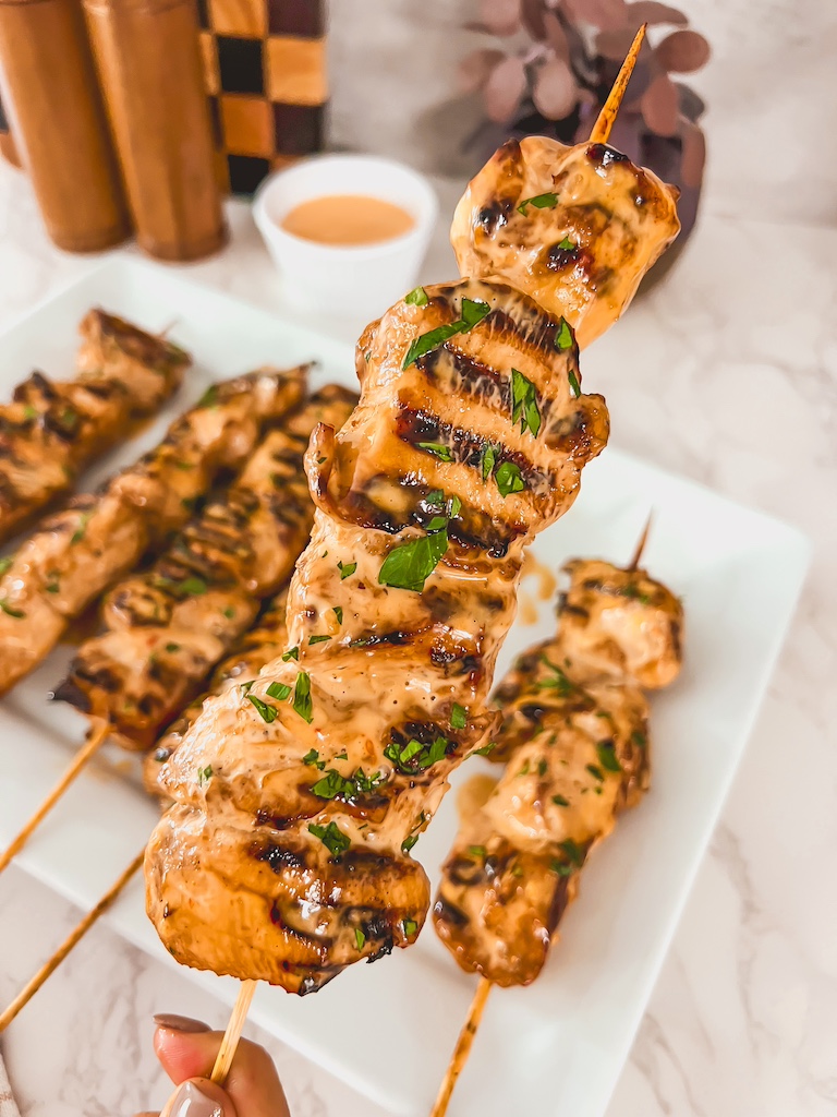 Easy bang bang chicken skewers served on a platter with dipping sauce