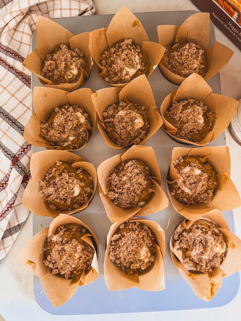 streusel toppings on pumpkin cheesecake muffin