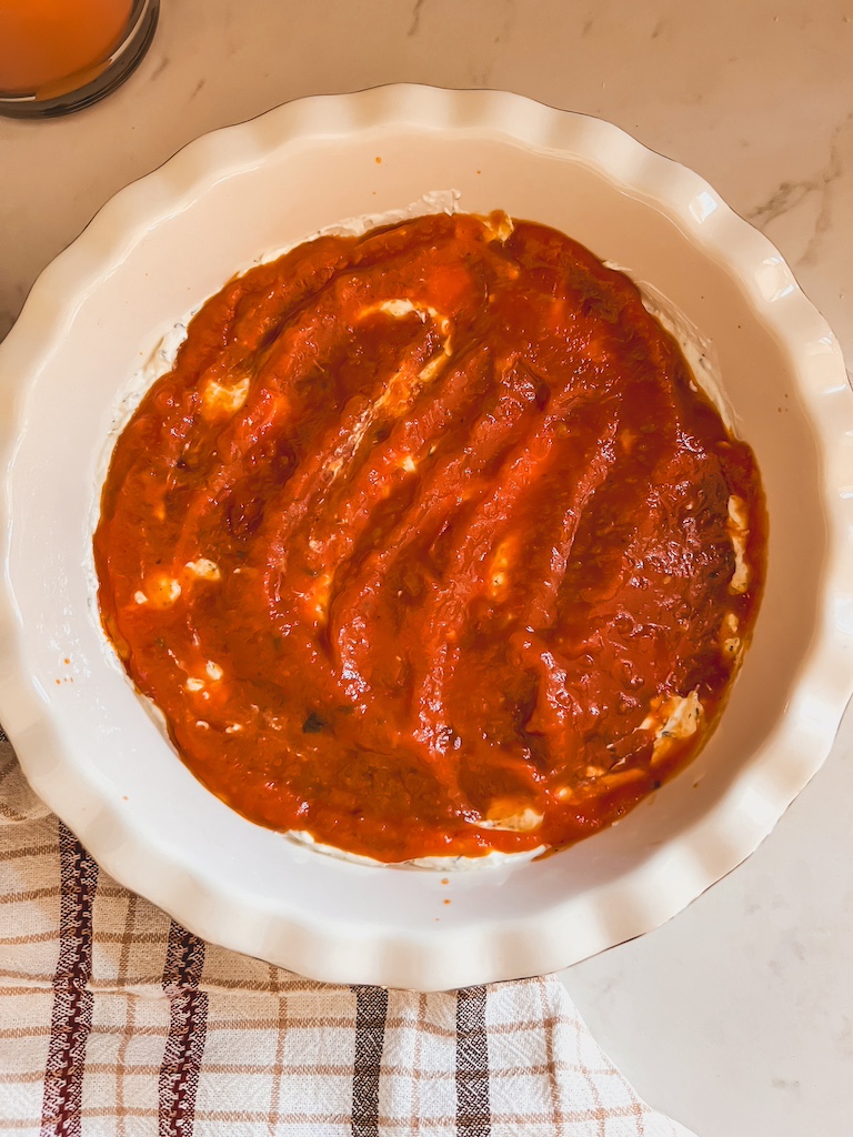cheese and marinara sauce layered in pie dis