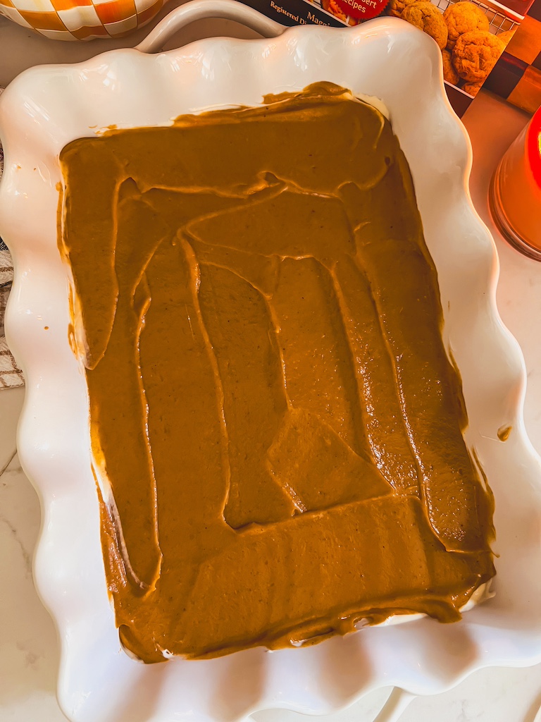 smoothing pumpkin filling over cheesecake layer