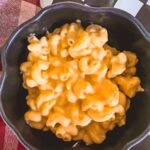 slow cooker mac and cheese in a black bowl