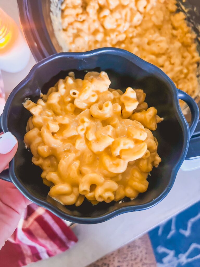 bowl of slow cooker mac and cheese in a black bowl