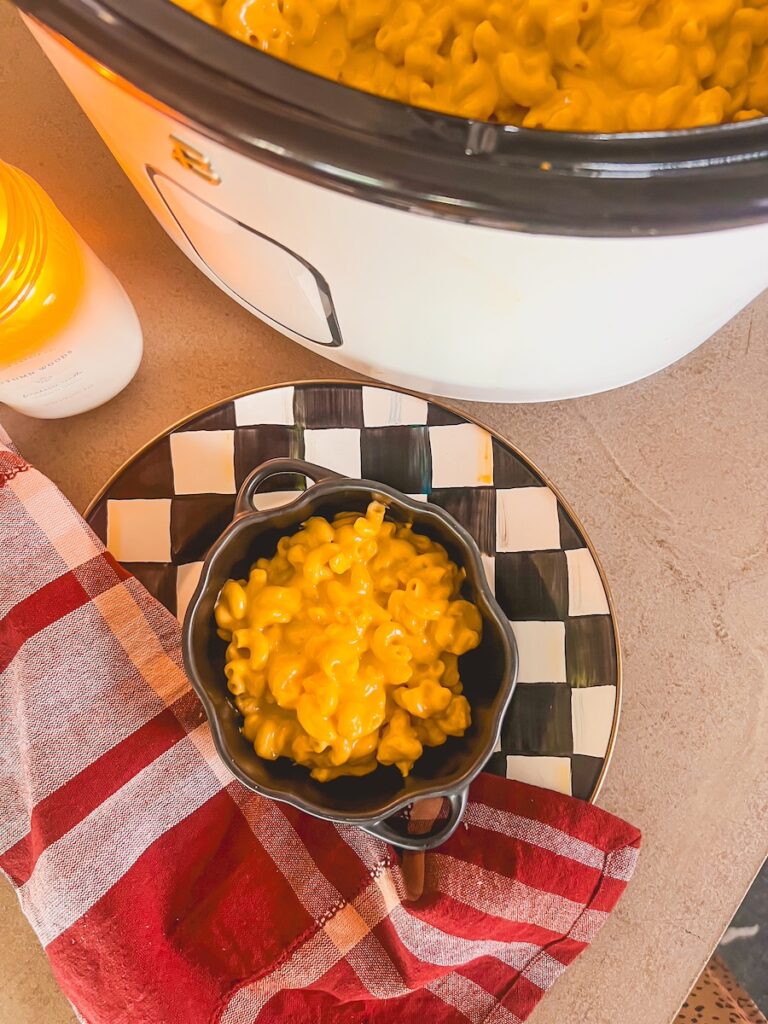 flat eye view of crockpot and bowl of mac and cheese