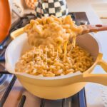 Close up of gooey cheese pull from one pot mac and cheese