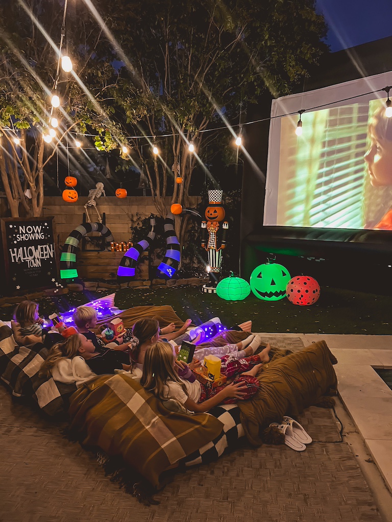 Family-friendly Halloween outdoor movie night with kids watching Halloweentown