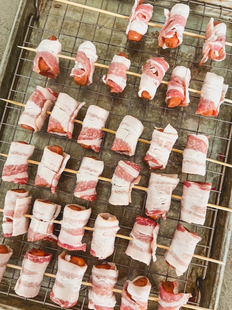 brown sugar smokies arranged on a wire rack on top of a baking tay