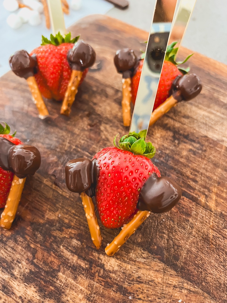 attach pretzels and marshmallows to strawberry