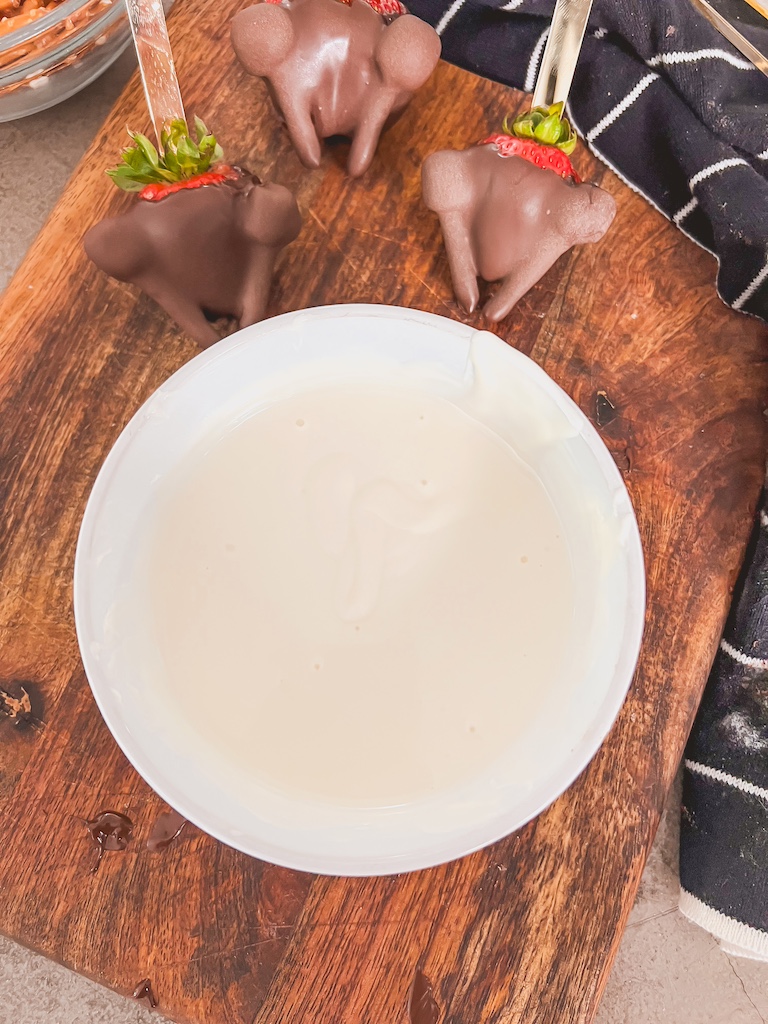 dip strawberry legs into white chocolate