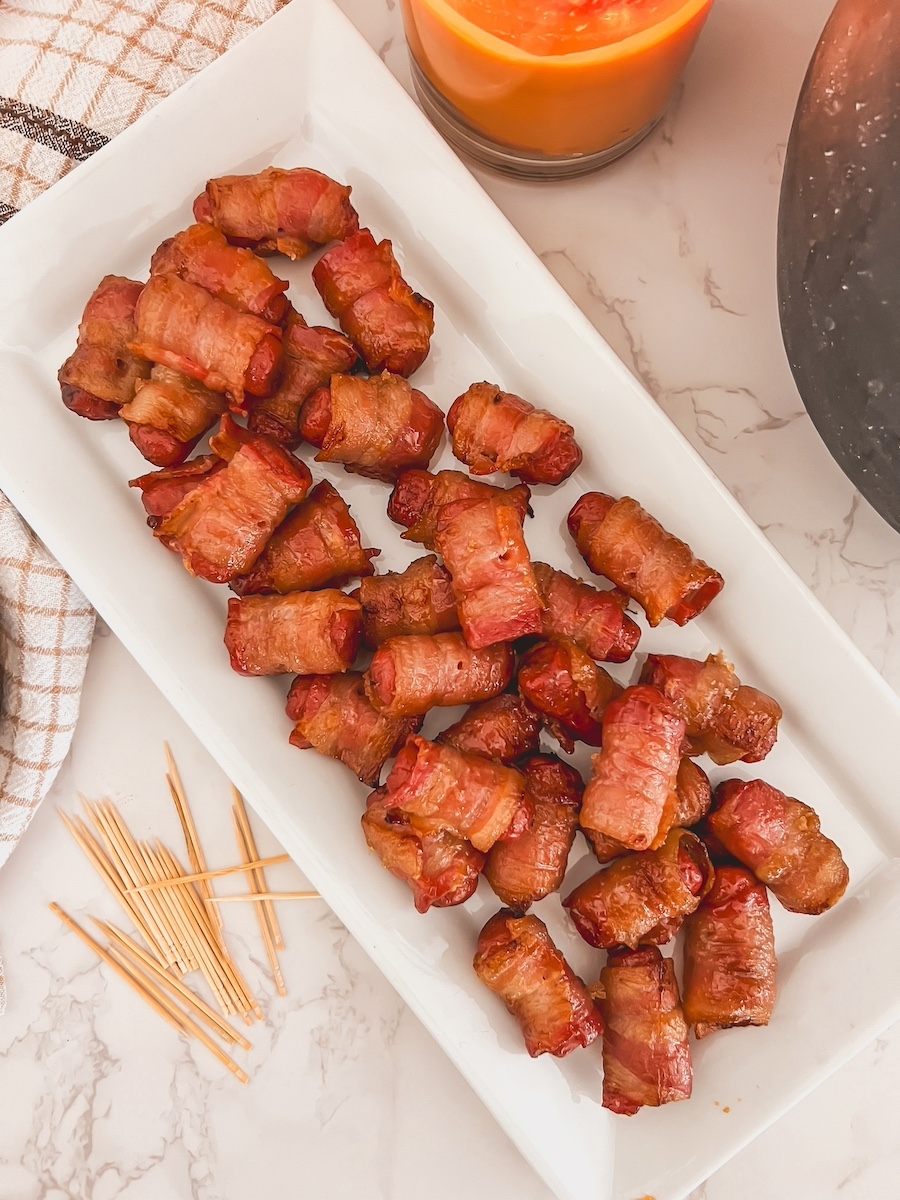 brown sugar smokies on a white platter with toothpicks