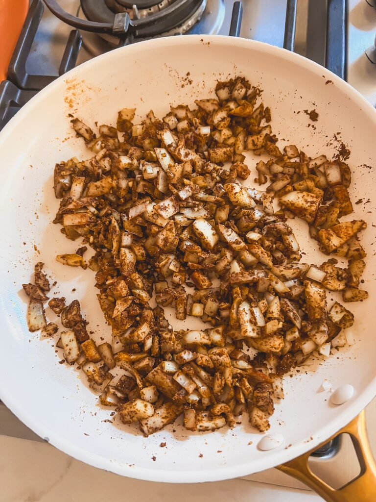 white onion in a saucepan with spices