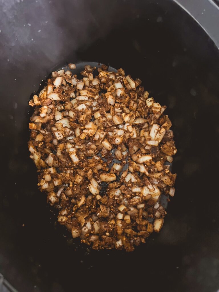 onion with spices in slow cooker