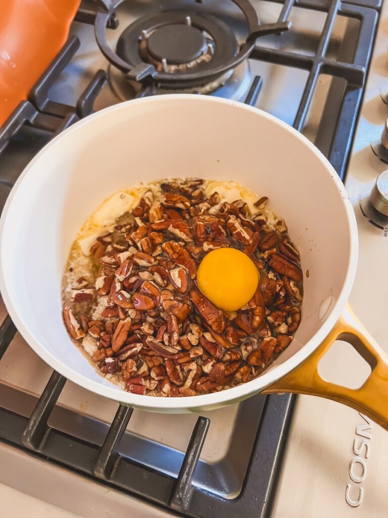 ingredients on stove top in a saucepan for pecan pie dip
