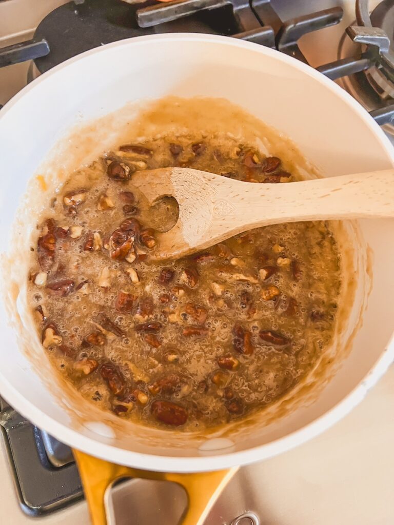 pecan pie dip in saucepan cooking on stove