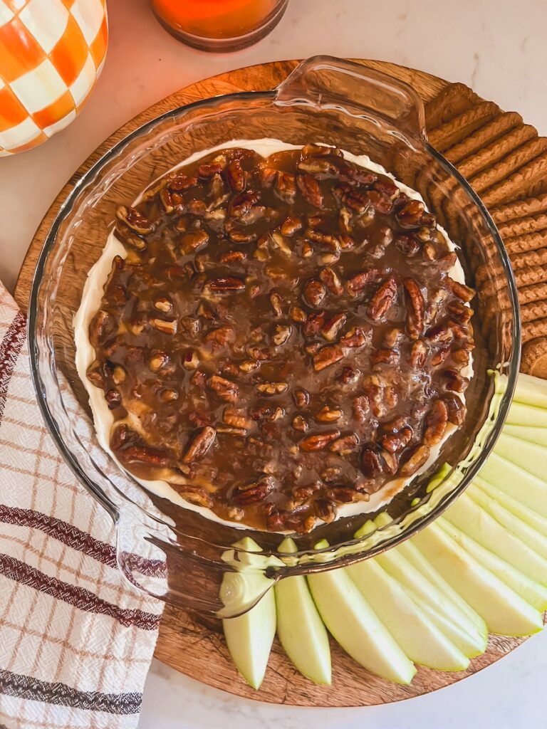 flatlay of pecan pie dip served along side green apples and biscoff cookies