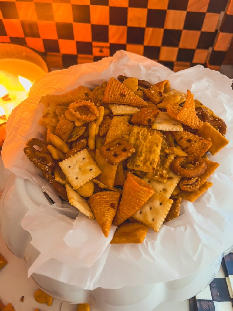 close up of million dollar snack mix with candle in a white bowl