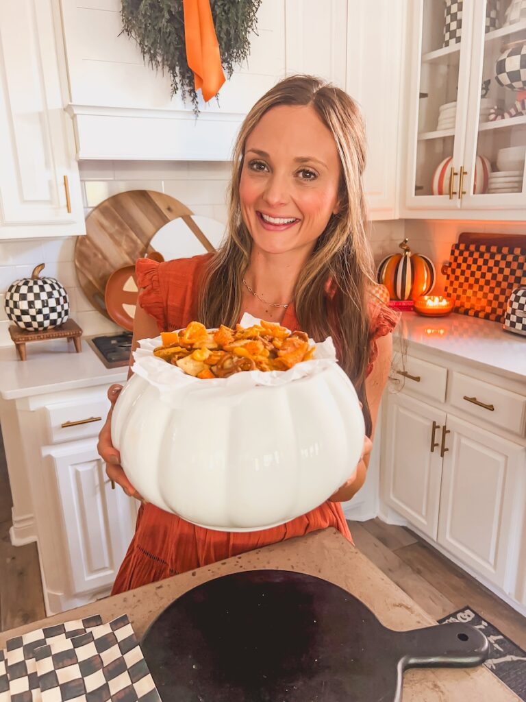 life by leanna holding bowl of million dollar snack mix