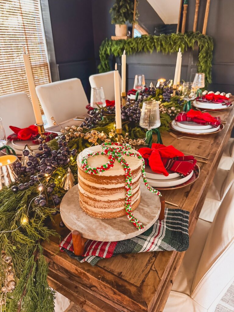 christmas cake on a festive christmas table decorated in classic christmas colors