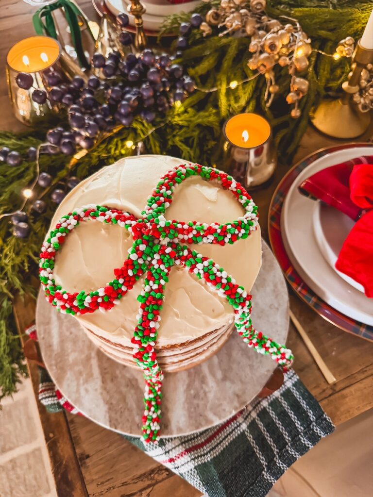 christmas bow cake hack on a cake stand with a festive christmas table