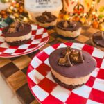 no bake peanut butter cheesecake cups on a red and white checkered plate festive for christmas