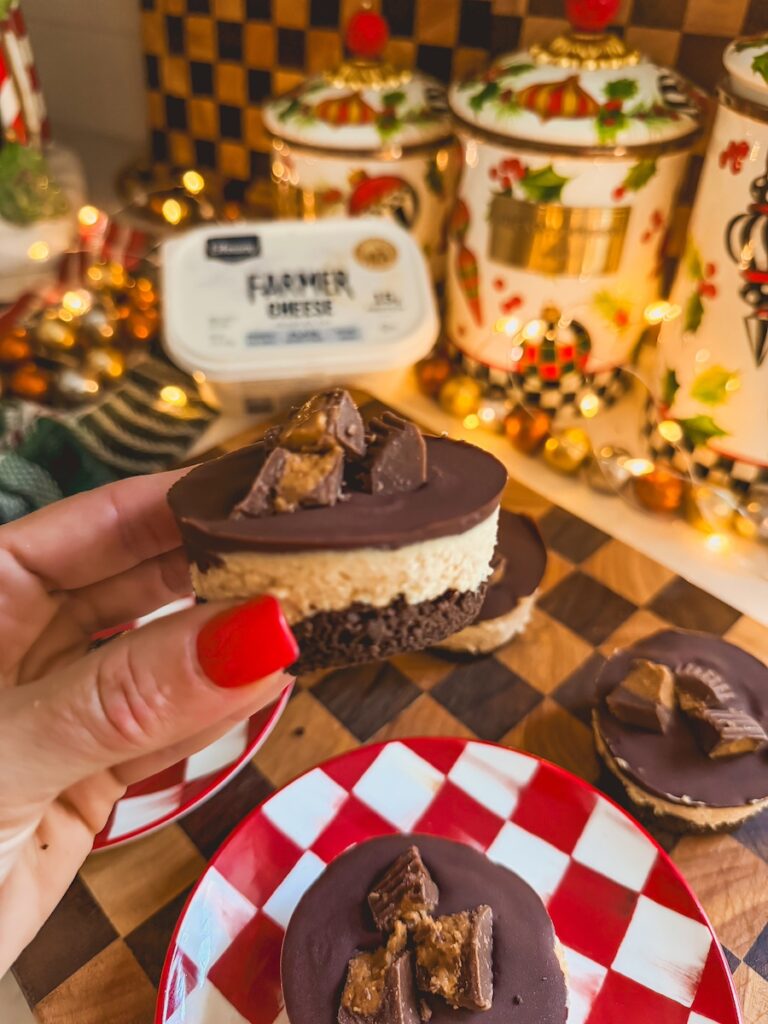 hand holding no bake peanut butter cheesecake cup