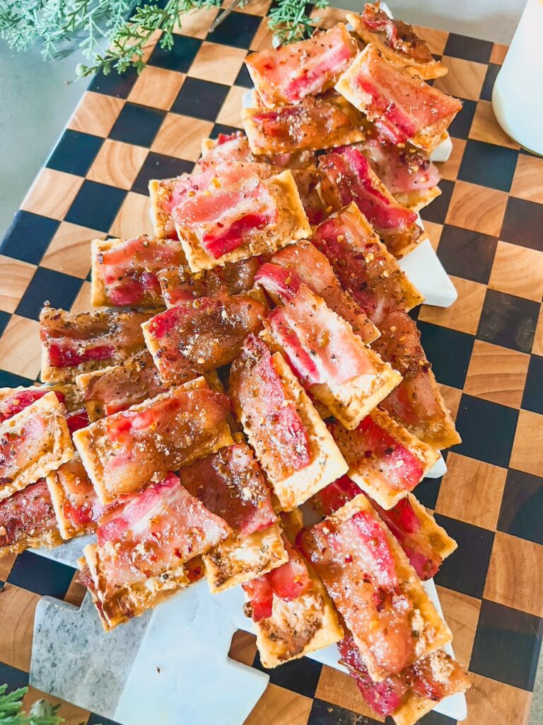 candied bacon crackers on a wood tray