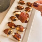 a prosciutto wrapped date on a toothpick