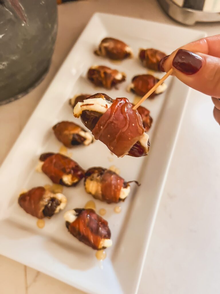 a prosciutto wrapped date on a toothpick
