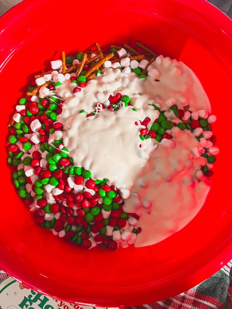 white chocolate poured ontop of christmas crack chex mix