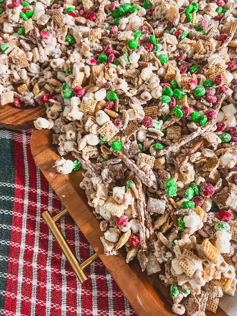 christmas crack snack mix layed out on a wooden tray