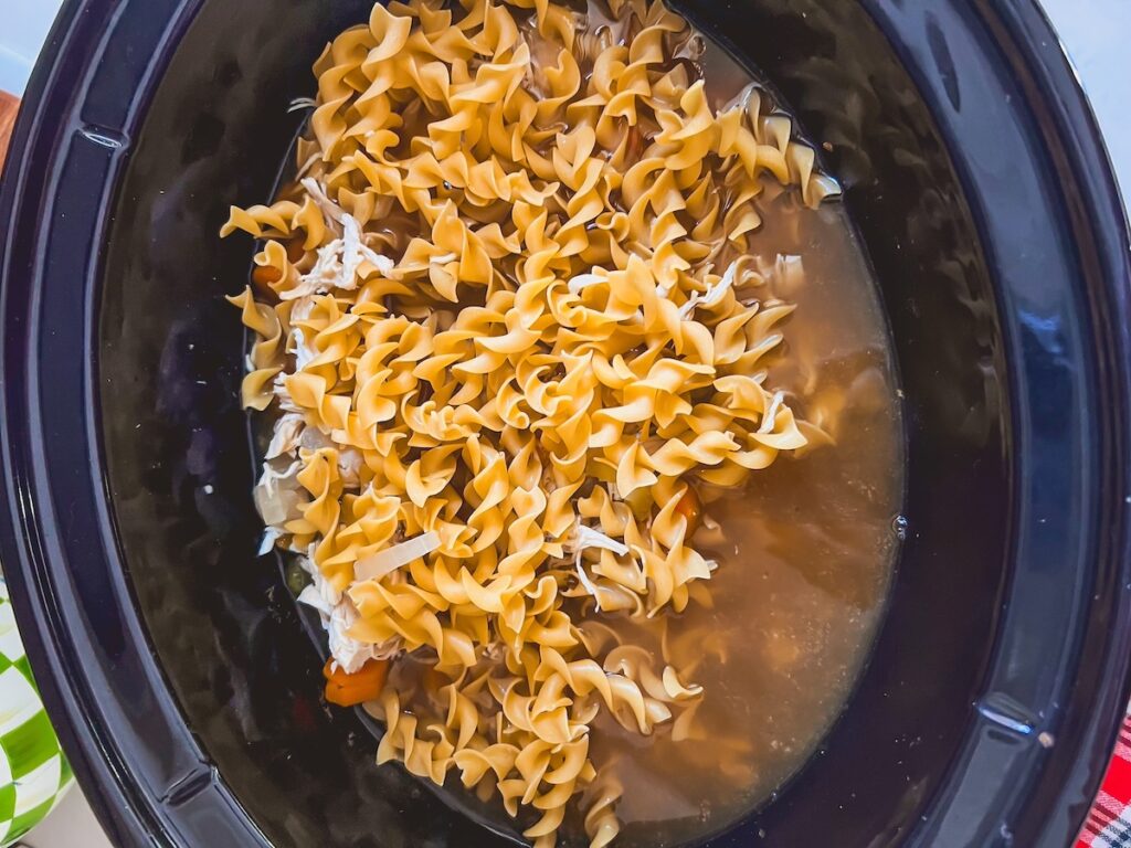 Egg noodles added to the slow cooker chicken noodle soup.