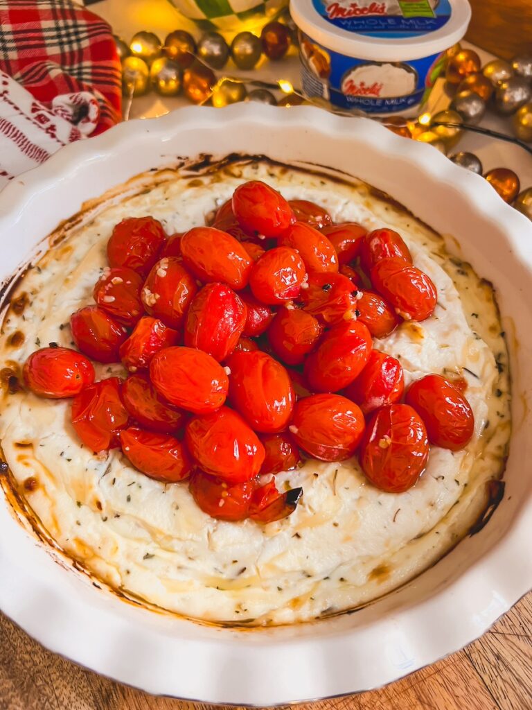 roasted tomatoes on top of baked ricotta dip