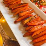 Maple glazed carrots on a white platter.