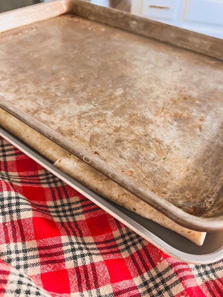 Sheet pan on top of the quesadilla to help it brown while it bakes. 