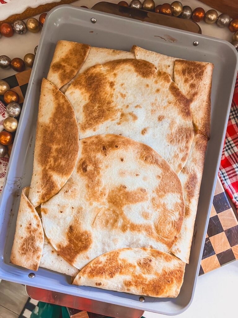 Baked sheet pan chicken fajita quesadilla resting.
