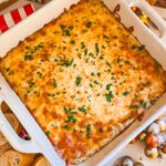 cheesy garlic bread dip in a white baking dish out of the oven baked golden