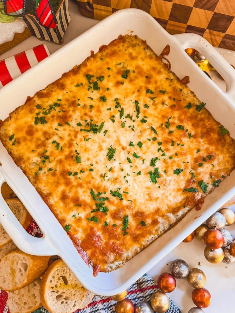 cheesy garlic bread dip in a white baking dish out of the oven baked golden