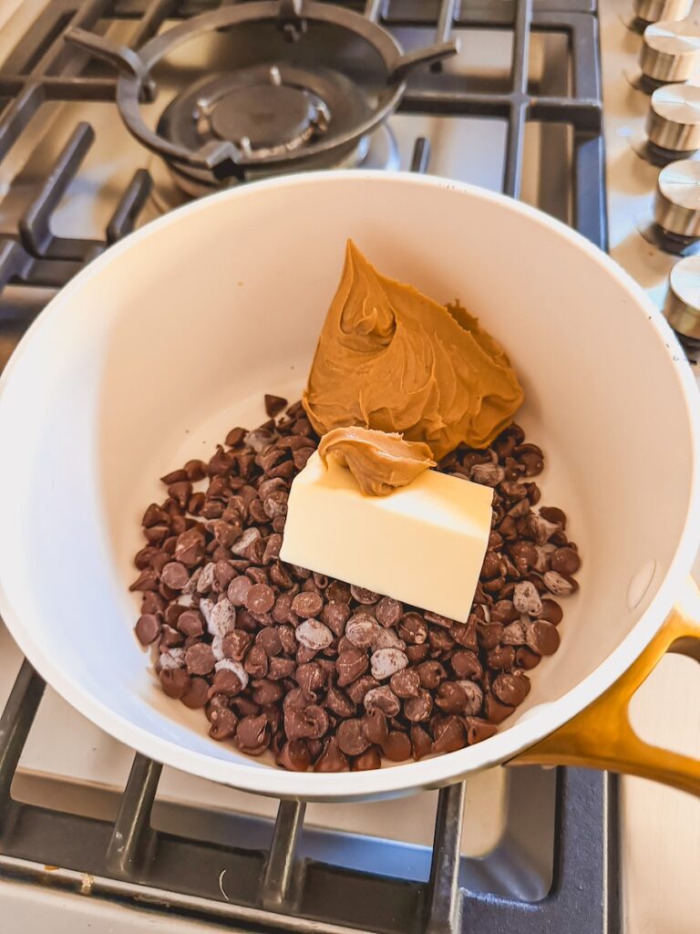 chocolate chips, butter and peanut butter in a pan the stove