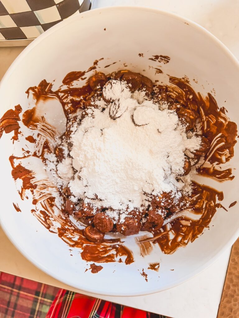 powdered sugar on top of ritz bits covered in chocolate
