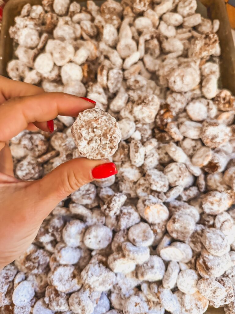 a hand grabbing one ritz bitz puppy chow