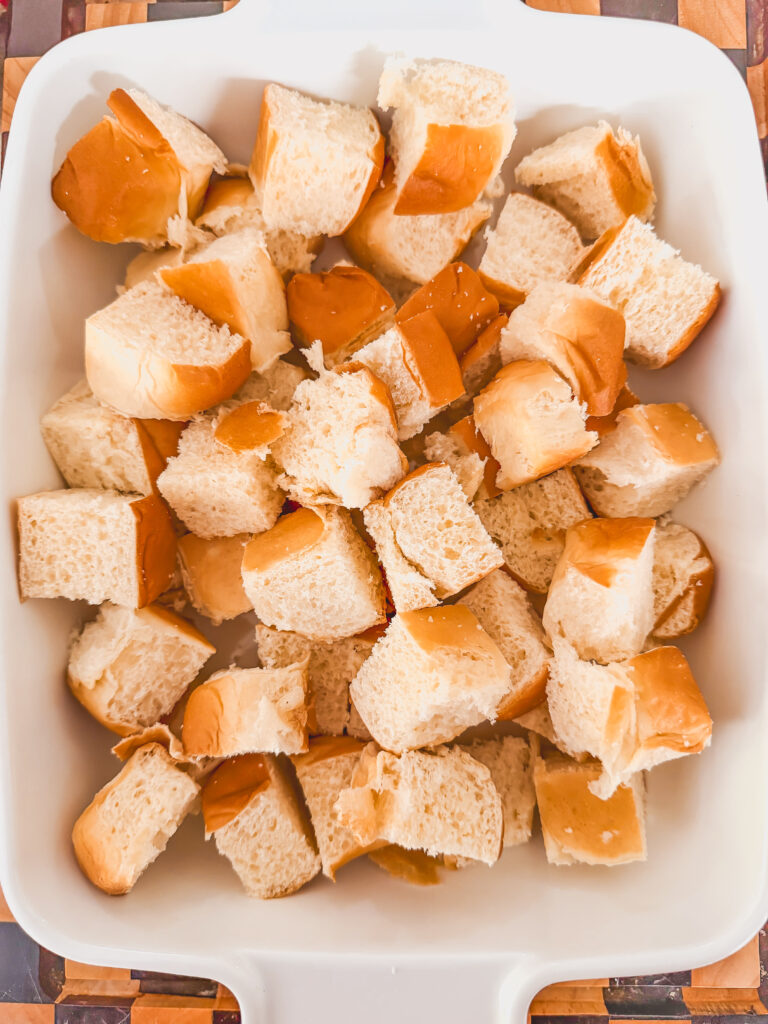 kings hawaiian original sweet rolls cut up in a white baking dish